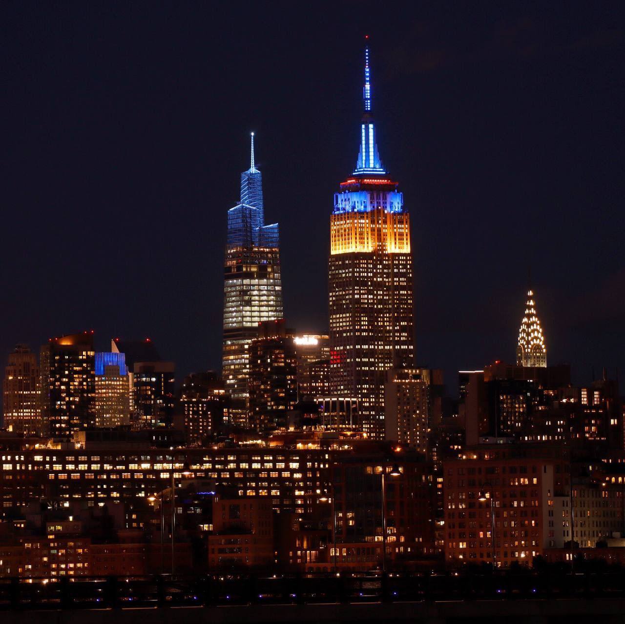 Empire State Building lights blue and yellow daily until spring end
