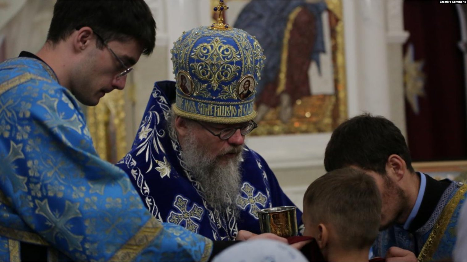 Archbishop fires teacher for Ukrainian colors, despite wearing them himself.