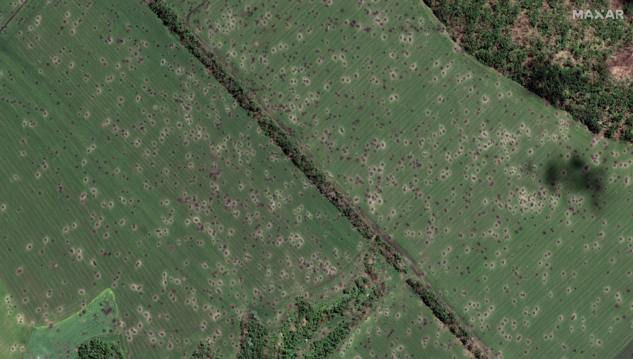Crater caused by mass bombardments in eastern Ukraine