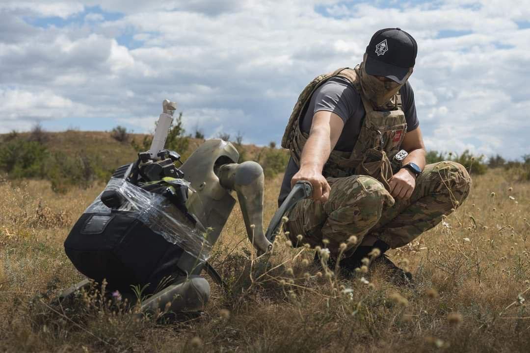 Robot dog high-fiving our Defender with Kurta unit