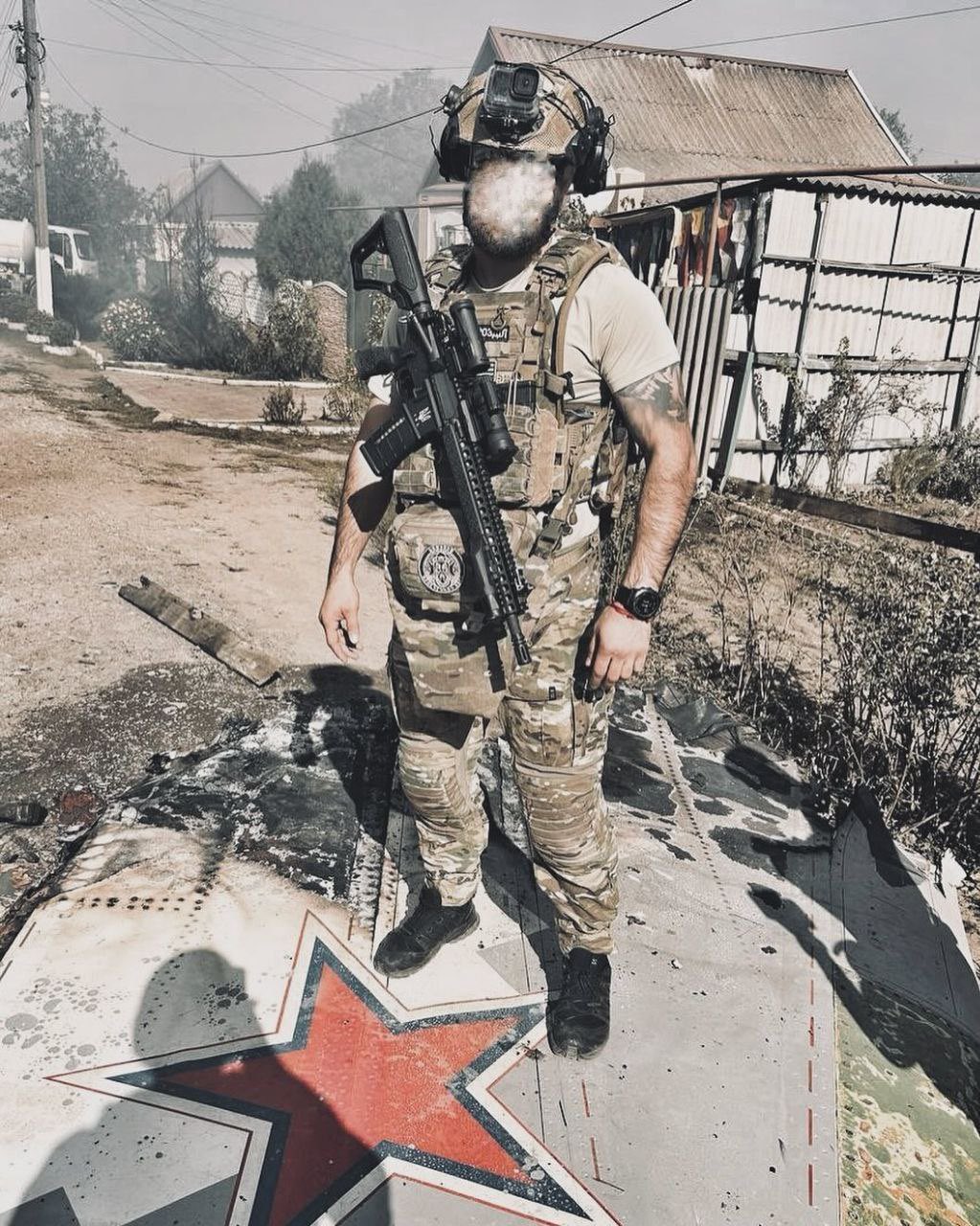 Ukrainian soldier on wreckage of downed Russian S-70 UAV