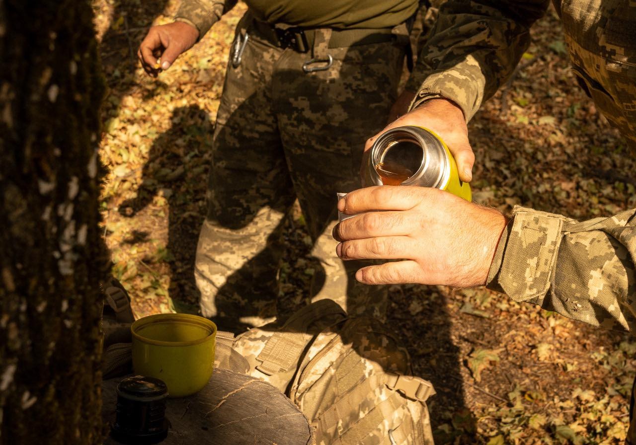 A bitter sip, coffee in a trench, warm thread of prayer