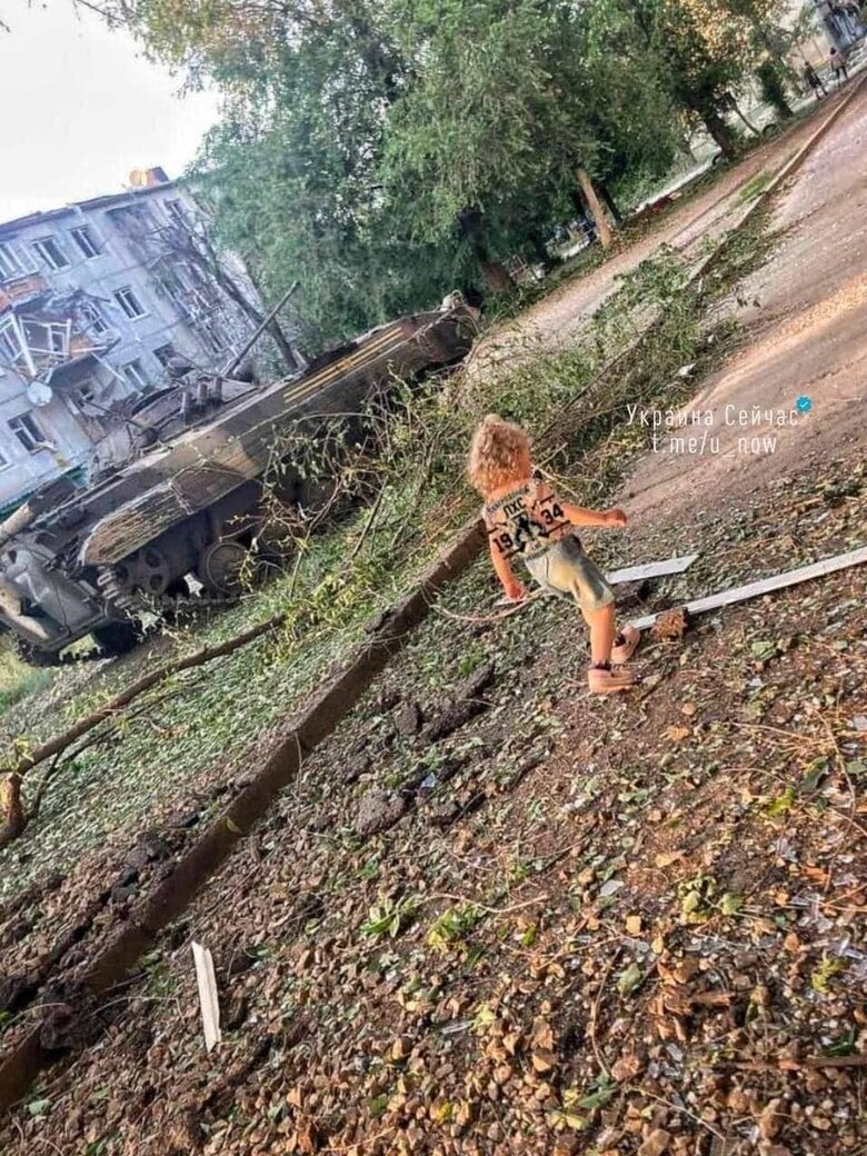 Ukrainian Childhood: Children Near a Destroyed Tank