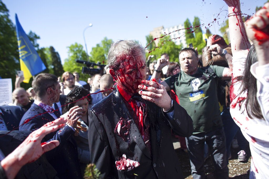 Activists pour red paint on Russian ambassador at Soviet soldiers cemetery