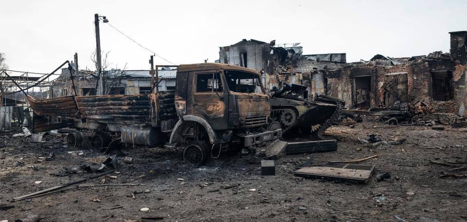 Liberated Trostyanets with Russian slogan on destroyed truck