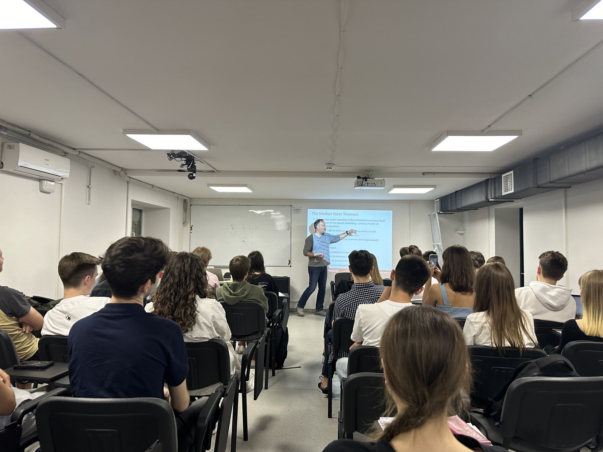 Professor teaches median voter theorem in Kyiv bomb shelter during air alert.