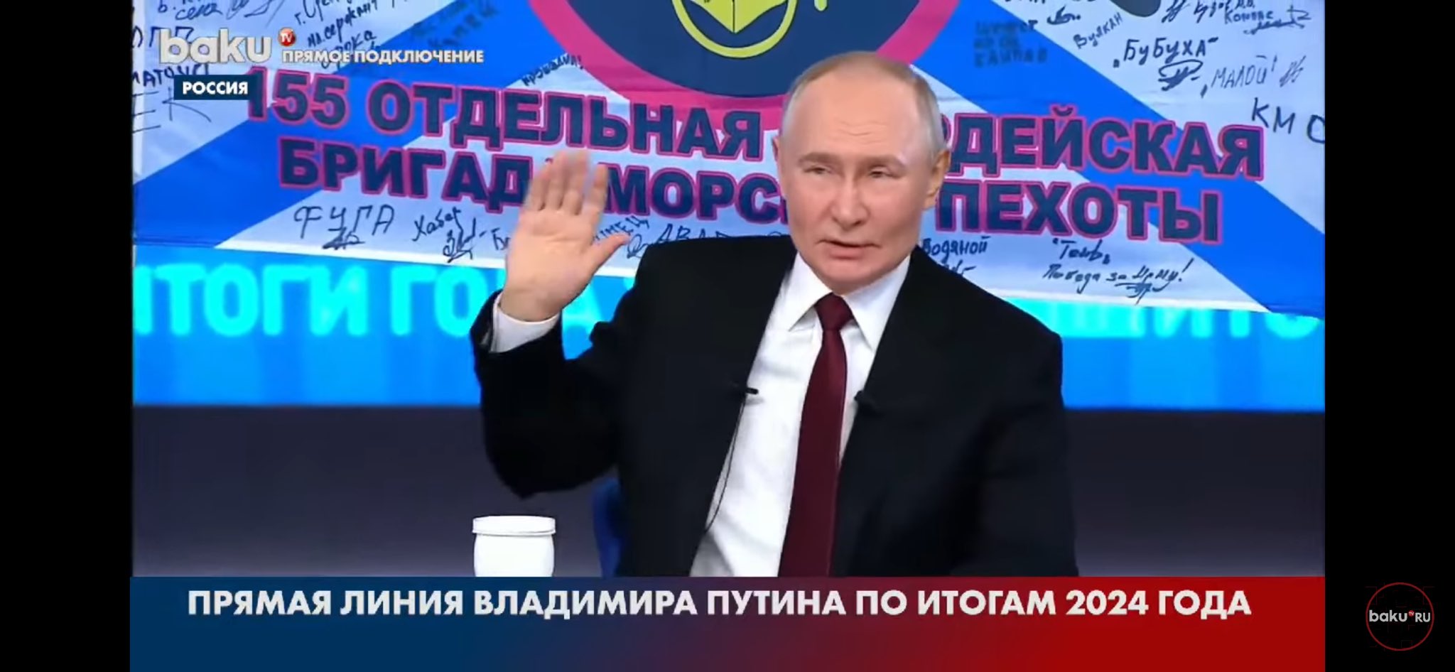Putin poses with flag of brigade that committed Bucha atrocities