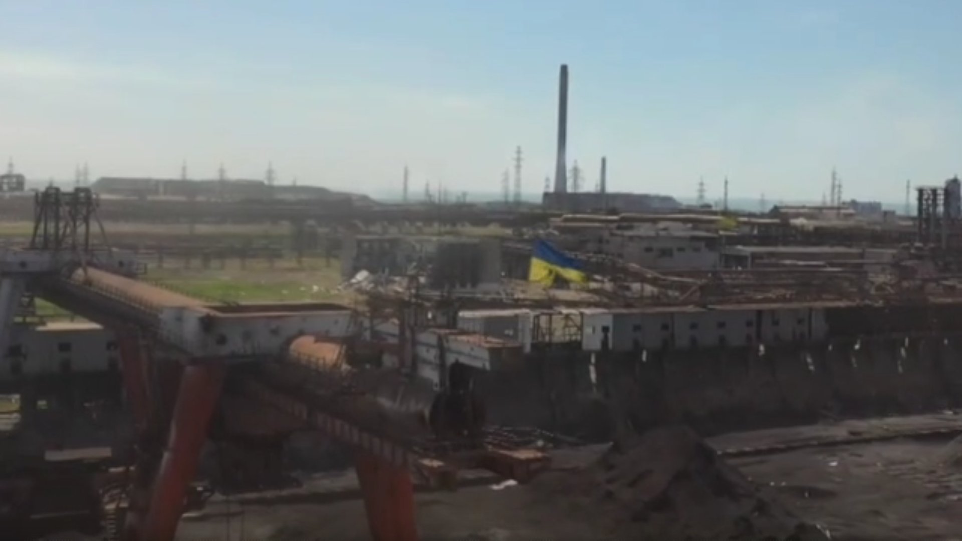 Ukrainian flag over Azovstal and Georgian ribbon in Mariupol
