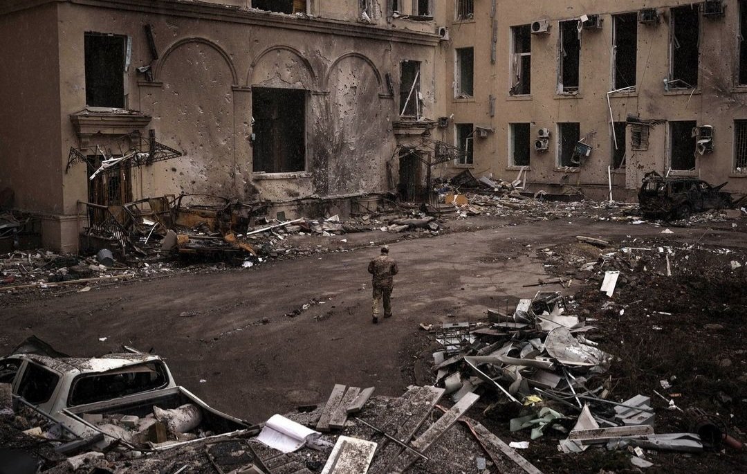 Soldier near destroyed building in Kharkiv