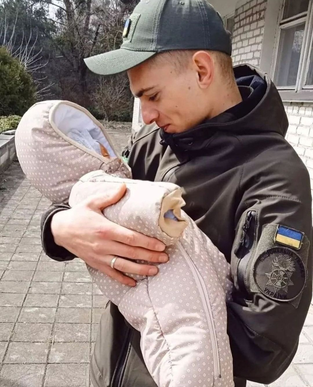 Ukrainian Guardsman Maksym holds his newborn son for first time