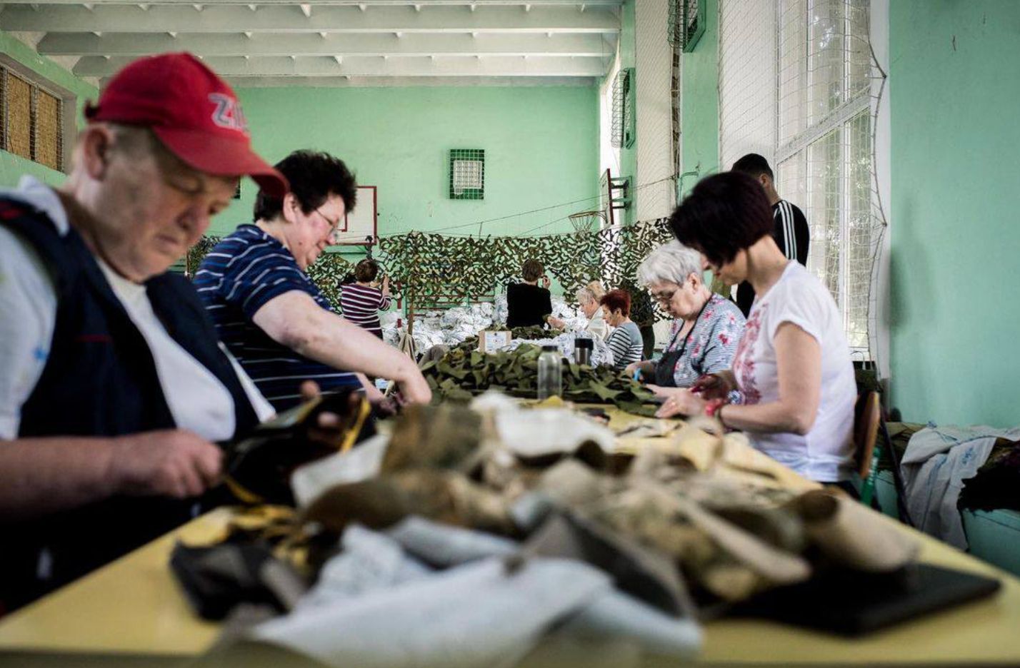 Poltava volunteers continue making camouflage nets for Ukrainian defenders after three years of war.
