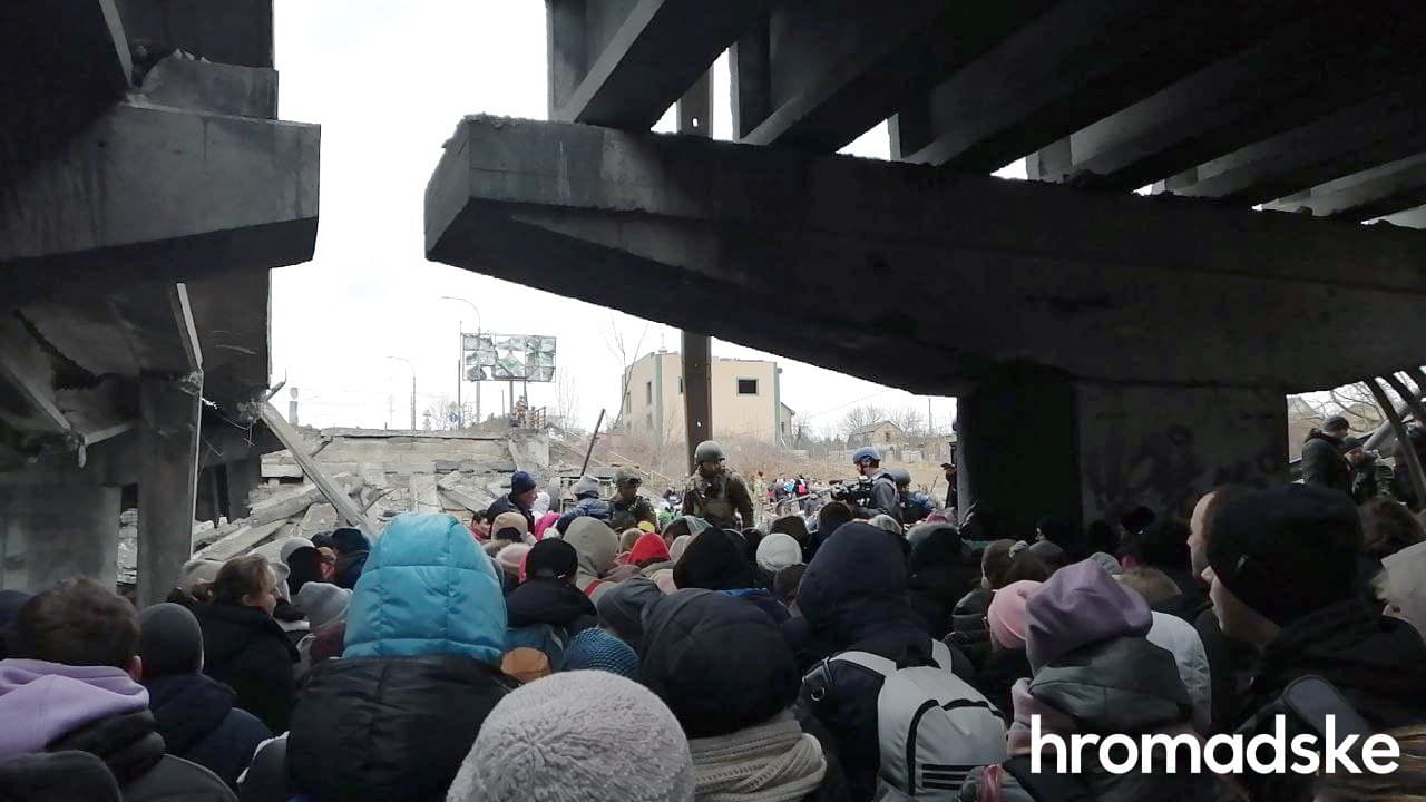 Residents of Irpen evacuate via ruined bridge