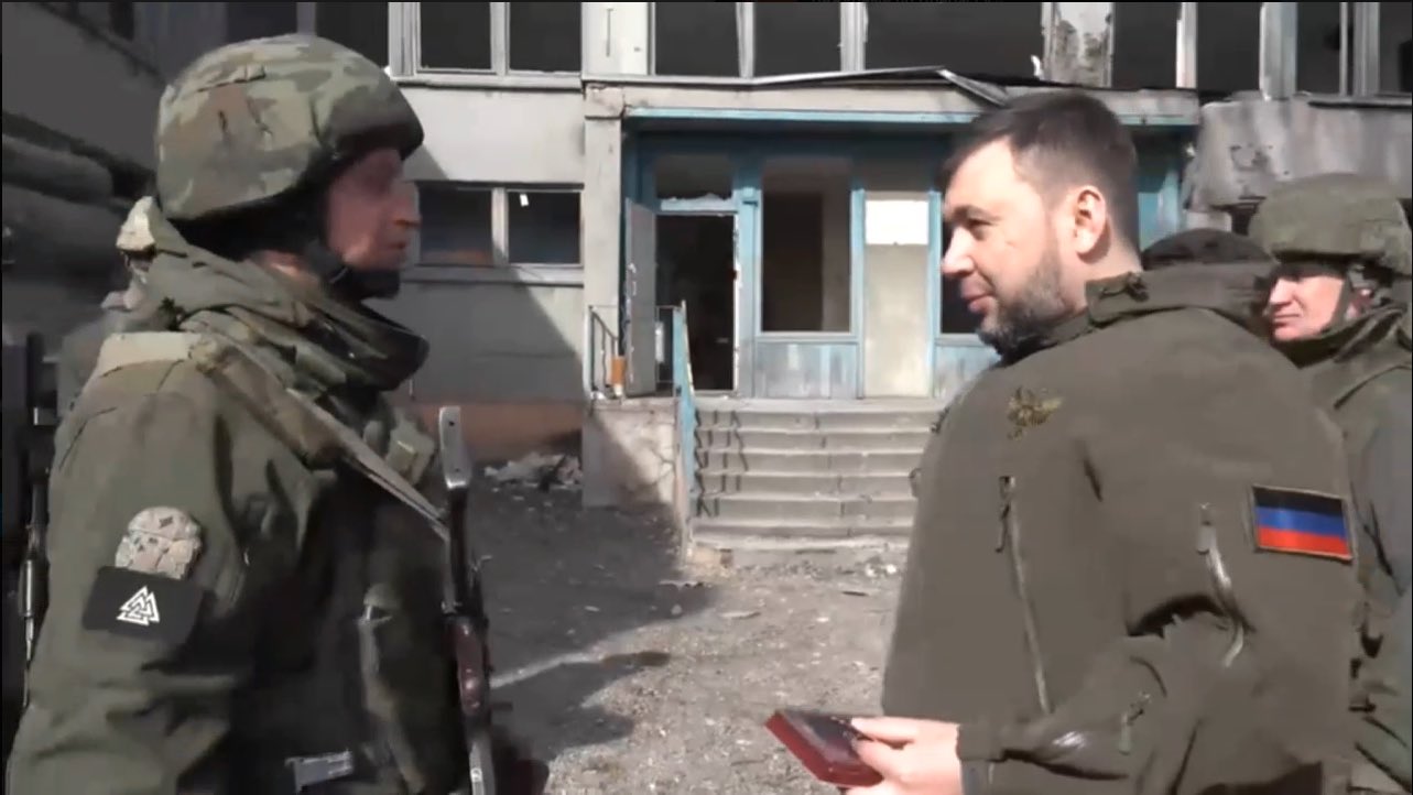 Pushilin decorates militant with Neo-Nazi patches in Mariupol.