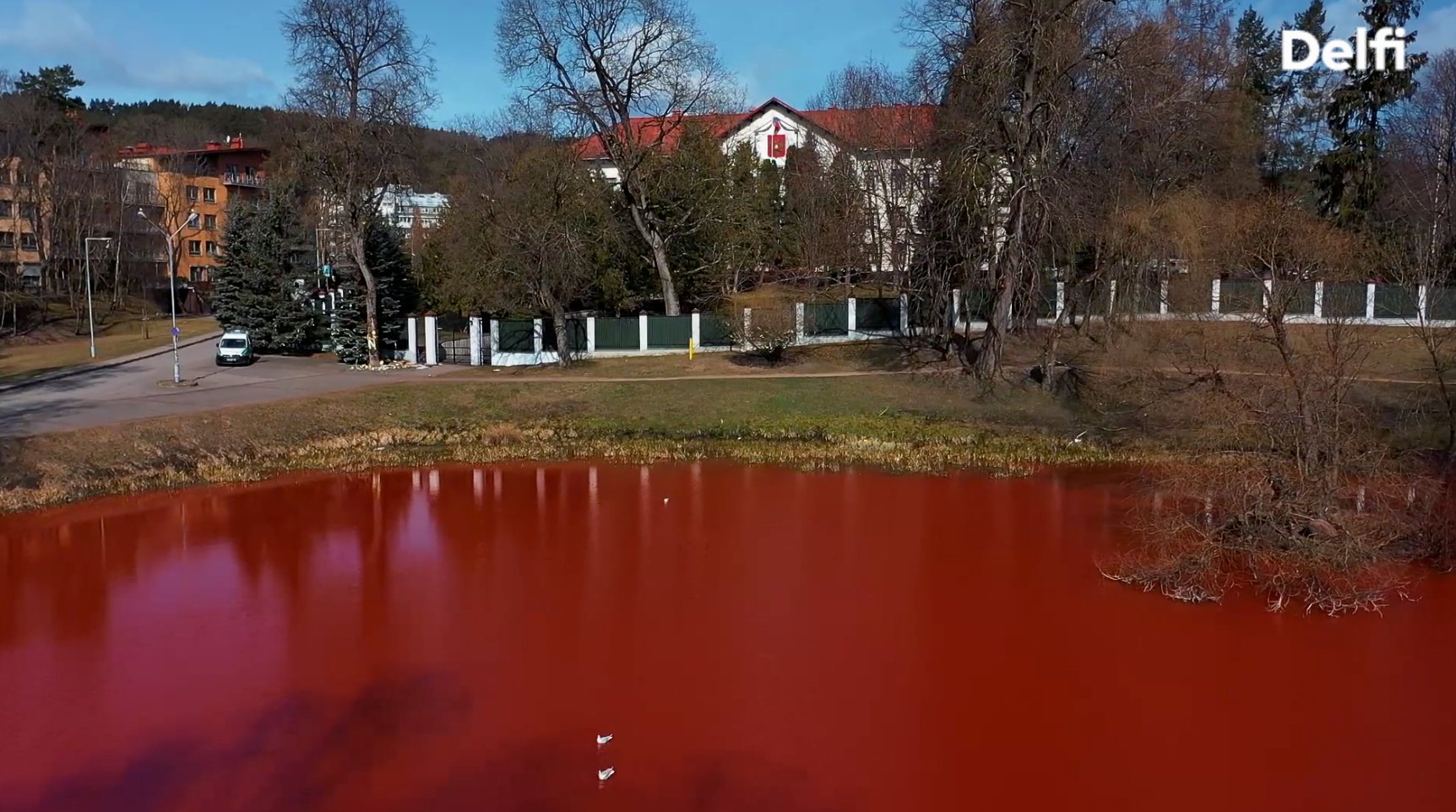 Activists dye lake near Russian Embassy red